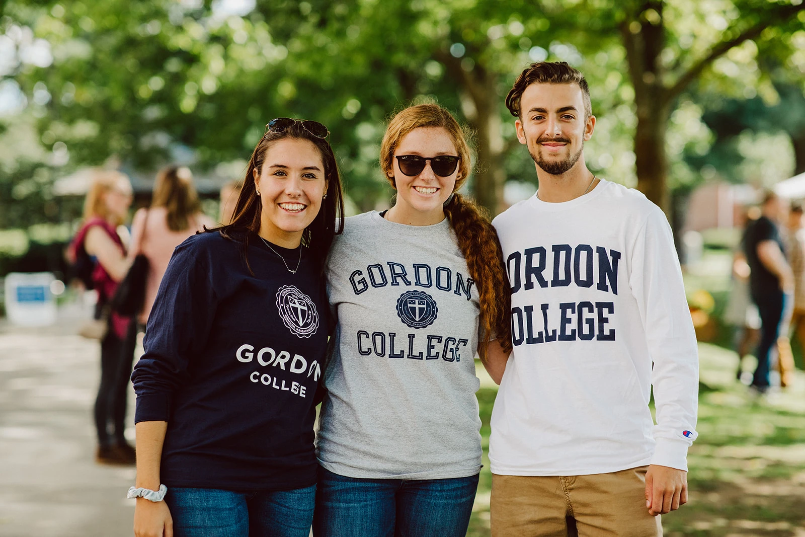 Three Gordon College students standing together outdoors.